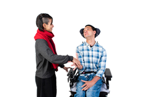 Image of a woman helping out a man in a wheelchair