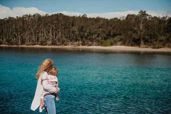 Picture of Ella holding Violet near a lake
