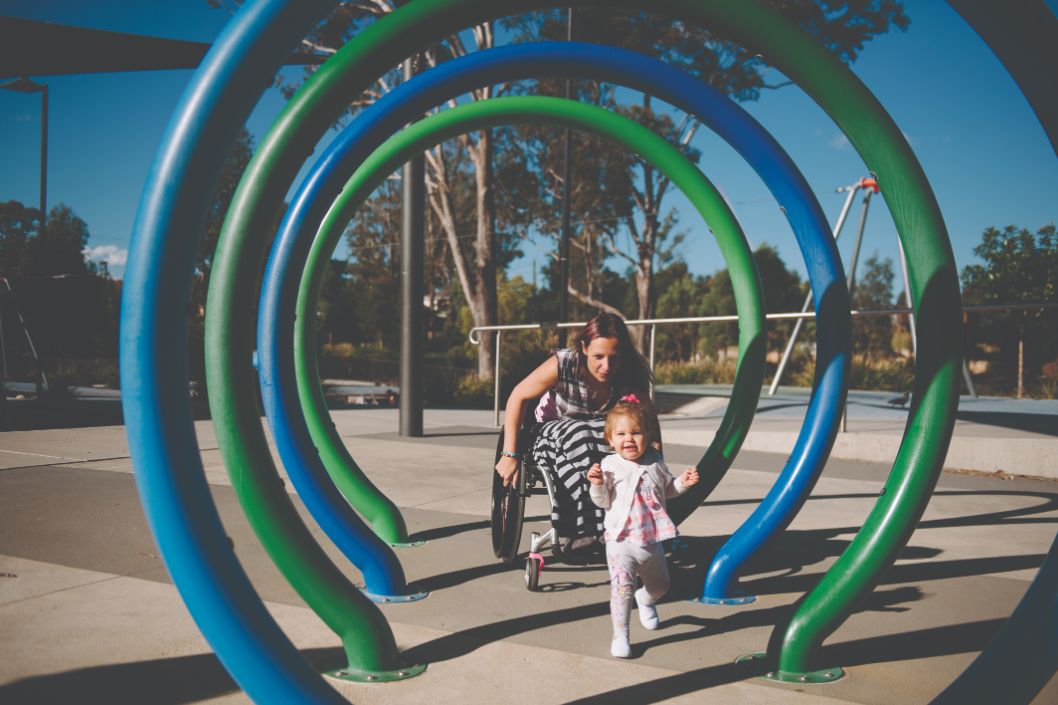 A picture of Rahni playing with her daughter in a playground
