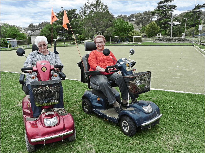 Ann and Margaret in  mobile carts on lawn bowel green