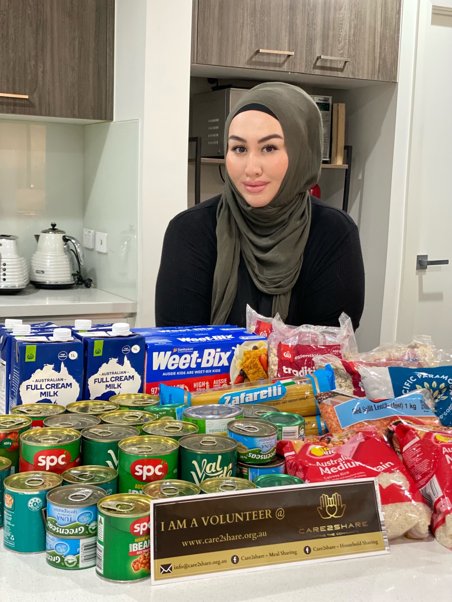 This is an image of Nabila Elrich with donated groceries.