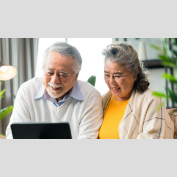 Elderly couple looking at a laptop.
